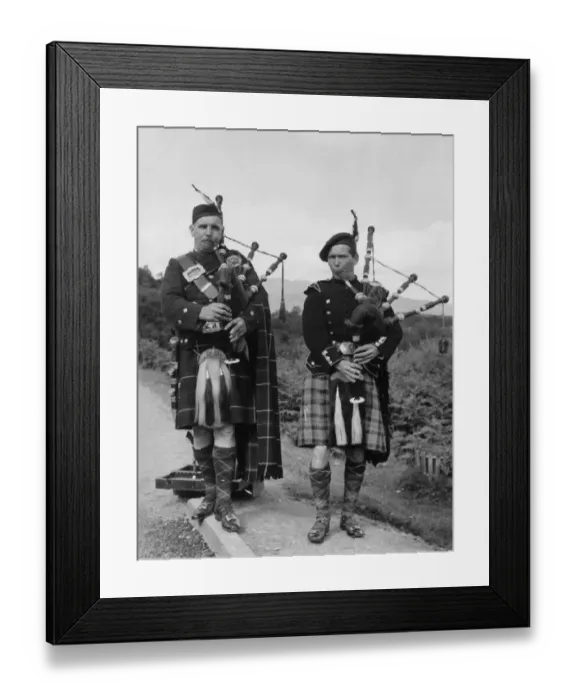 Framed Print : Two bagpipers on a road in the Trossachs, Scotland Framed Print : Two bagpipers on a road in the Trossachs, Scotland