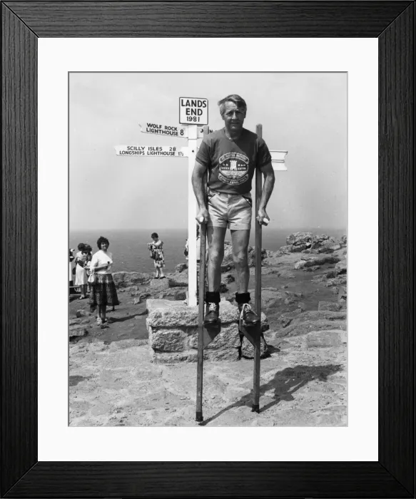 Framed Print : Marathon stilt walker at Lands End, Cornwall Framed Print : Marathon stilt walker at Lands End, Cornwall
