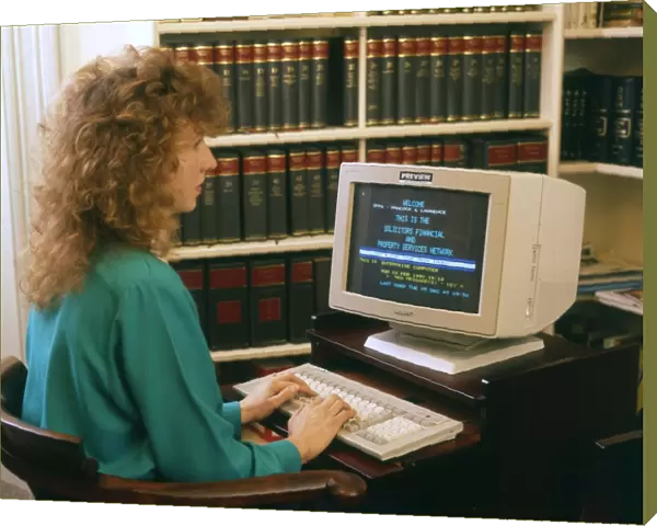 Young woman working at a computer in a solicitors office