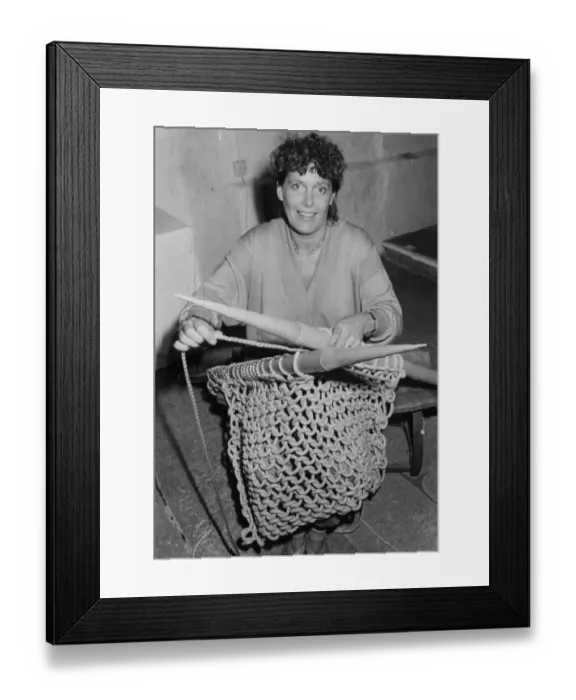 Framed Print : Woman knitting with six foot needles Framed Print : Woman knitting with six foot needles