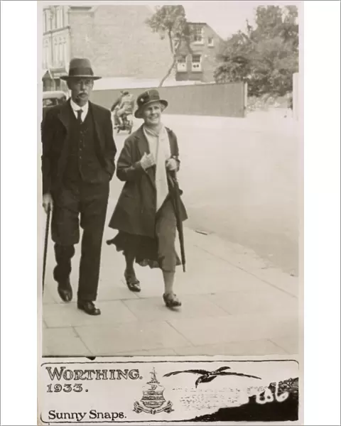 Couple strolling down a street in Worthing - Sunny Snaps
