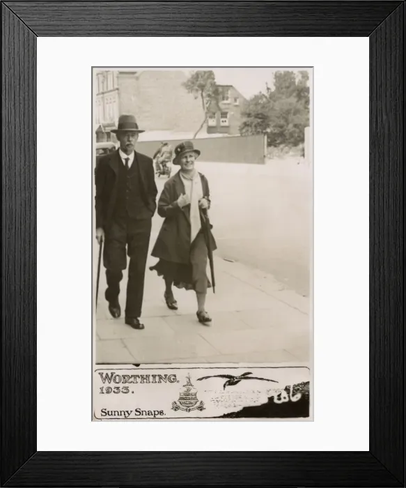 Framed Print : Couple strolling down a street in Worthing - Sunny Snaps Framed Print : Couple strolling down a street in Worthing - Sunny Snaps
