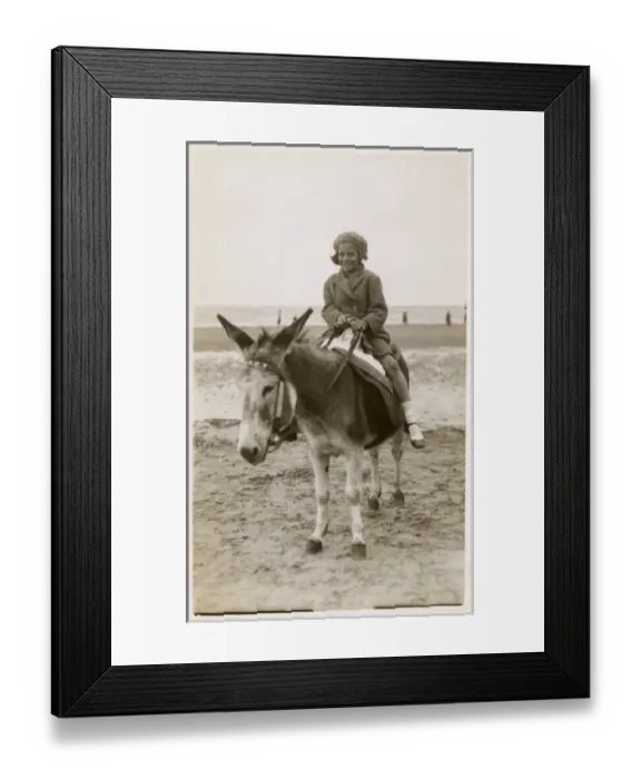 Framed Print : Smiling young girl taking a donkey ride - Margate, Kent Framed Print : Smiling young girl taking a donkey ride - Margate, Kent