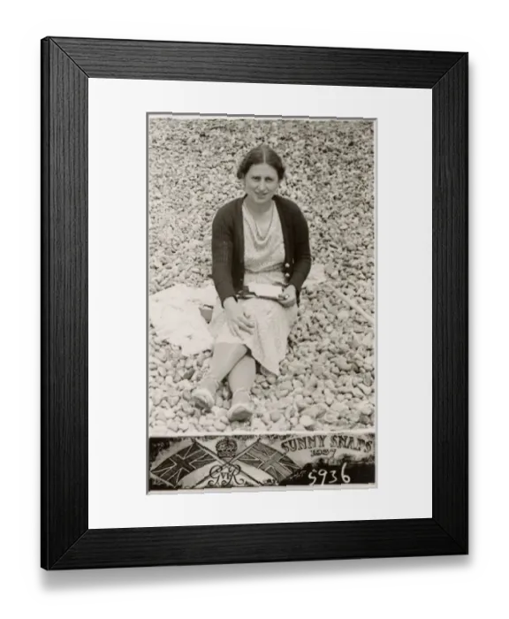 Framed Print : Lady on a south coast beach writing postcards to family Framed Print : Lady on a south coast beach writing postcards to family