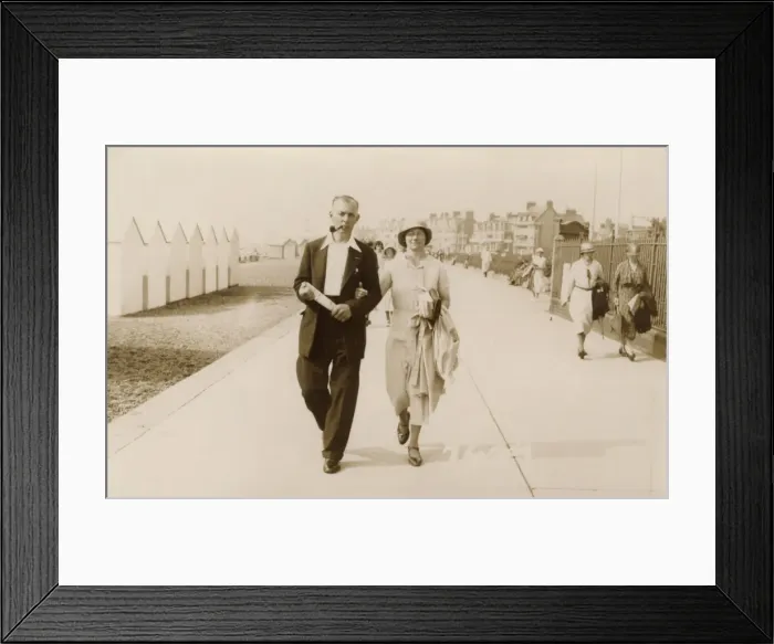 Framed Print : Couple on holiday stroll along the promenade at Felixstowe Framed Print : Couple on holiday stroll along the promenade at Felixstowe