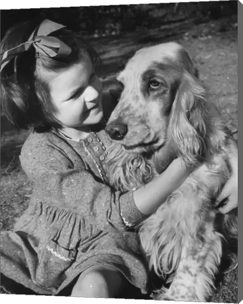 Little girl and dog in the garden
