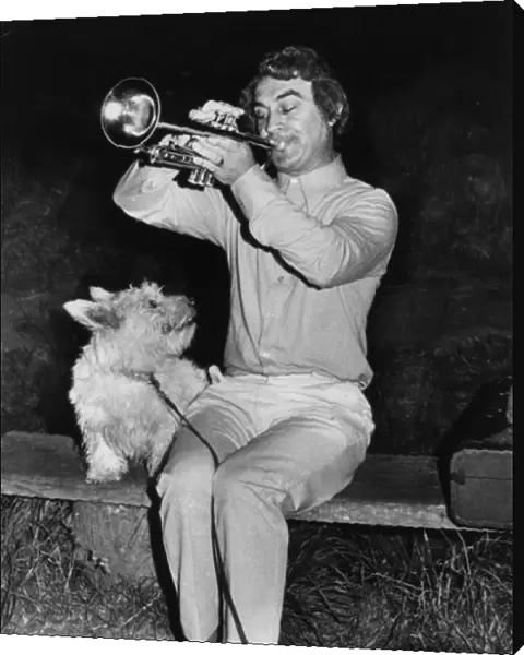 Man playing trumpet, dog listening