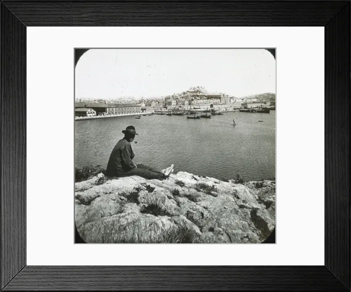 Framed Print : Cartagena - Black and white- man sitting on rock in foreground overlooking harbour Date Framed Print : Cartagena - Black and white- man sitting on rock in foreground overlooking harbour Date
