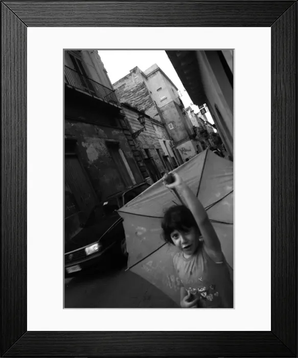 Framed Print : Girl in street with umbrella - Lecce, Italy Framed Print : Girl in street with umbrella - Lecce, Italy