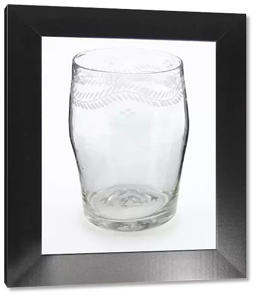 Tumbler. Barrel-shaped glass tumbler engraved with a border of meandering foliage