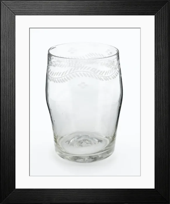 Framed Print : Tumbler. Barrel-shaped glass tumbler engraved with a border of meandering foliage Framed Print : Tumbler. Barrel-shaped glass tumbler engraved with a border of meandering foliage