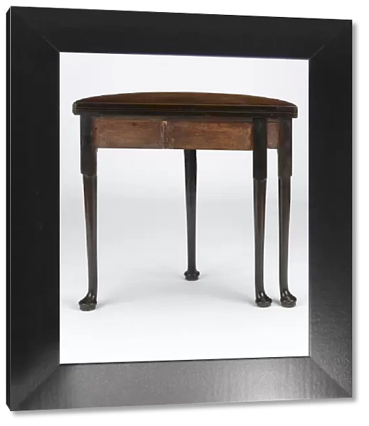 Tea table. Mahogany tea table with a folding half-round top, on turned