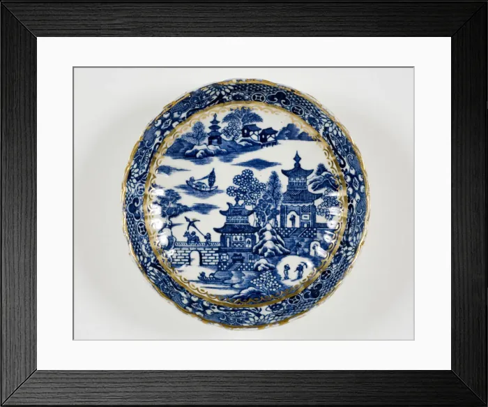 Framed Print : Saucer made from porcelain, transfer-printed in underglaze blue with the Framed Print : Saucer made from porcelain, transfer-printed in underglaze blue with the