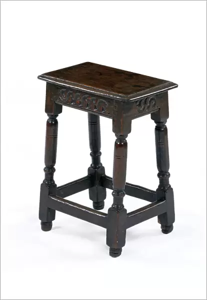 Stool. One of six matching oak joined stools with a carved frieze