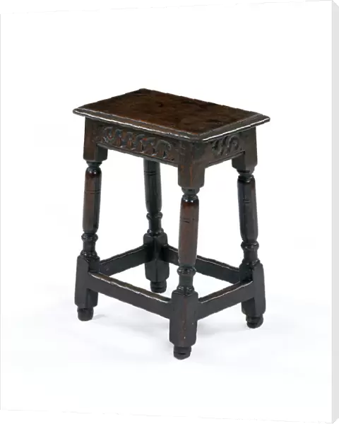 Stool. One of six matching oak joined stools with a carved frieze
