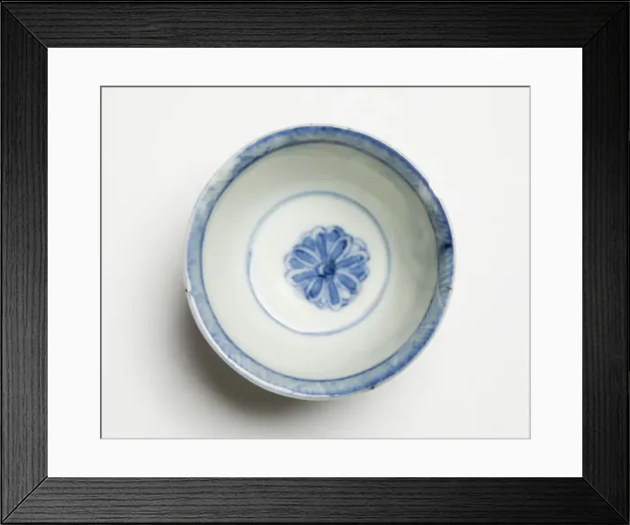 Framed Print : Tea bowl. Porcelain tea bowl decorated in underglaze blue with four petal-shaped Framed Print : Tea bowl. Porcelain tea bowl decorated in underglaze blue with four petal-shaped