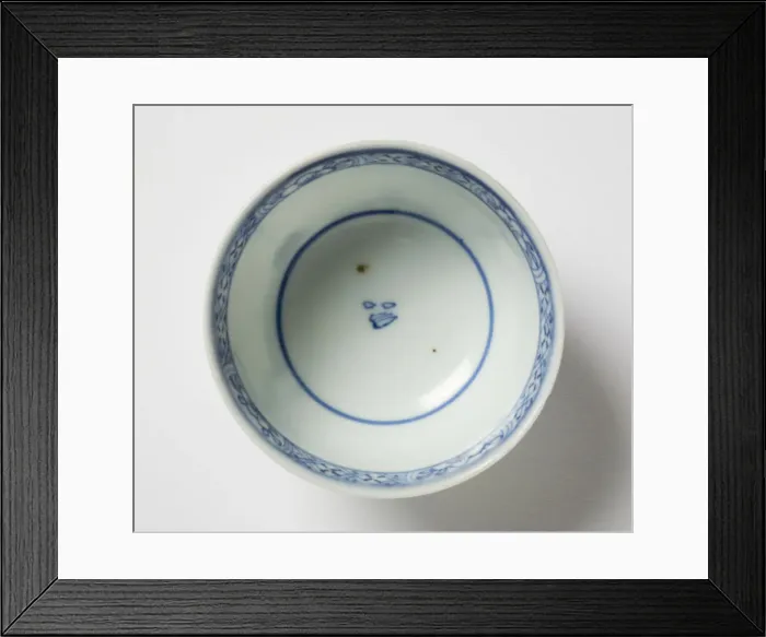Framed Print : Tea bowl. Porcelain tea bowl with cobalt blue underglaze decoration of three figures Framed Print : Tea bowl. Porcelain tea bowl with cobalt blue underglaze decoration of three figures
