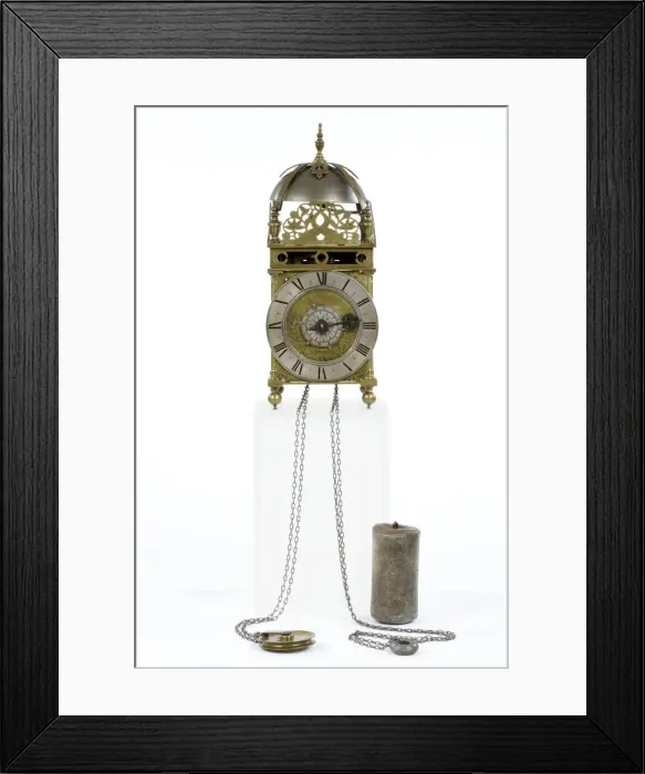 Framed Print : Clock. Brass and metal lantern clock on four ball feet Framed Print : Clock. Brass and metal lantern clock on four ball feet