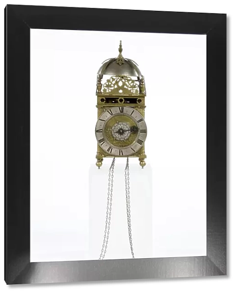 Clock. Brass and metal lantern clock on four ball feet