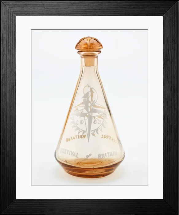 Framed Print : Decanter. Tangerine coloured glass decanter of conical form Framed Print : Decanter. Tangerine coloured glass decanter of conical form