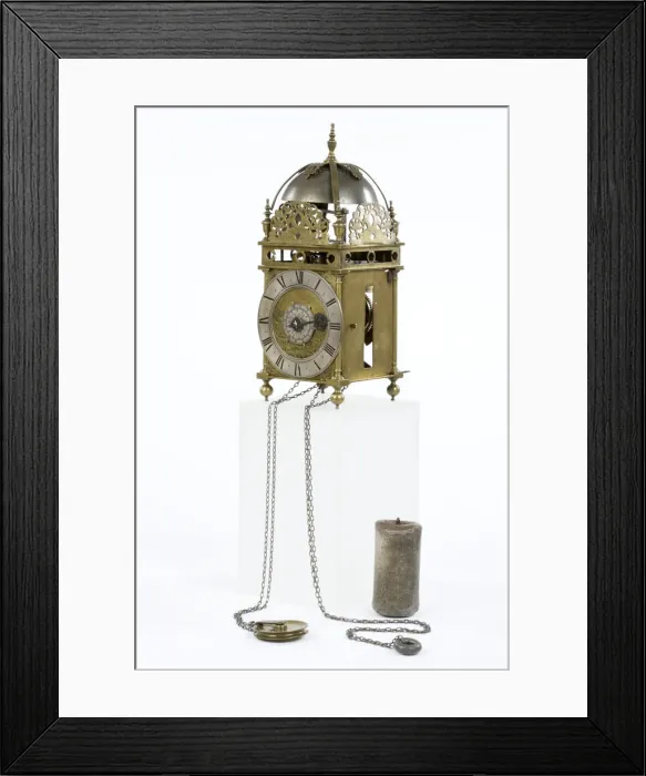 Framed Print : Clock. Brass and metal lantern clock on four ball feet Framed Print : Clock. Brass and metal lantern clock on four ball feet