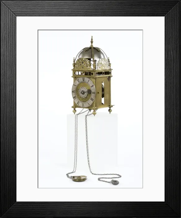 Framed Print : Clock. Brass and metal lantern clock on four ball feet Framed Print : Clock. Brass and metal lantern clock on four ball feet