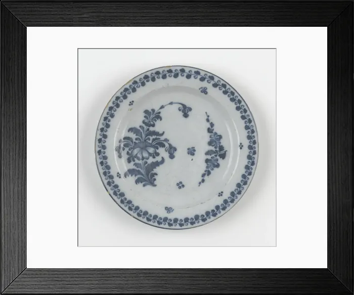 Framed Print : Plate. Tin-glazed earthenware plate painted in a blue floral design with a foliate border Framed Print : Plate. Tin-glazed earthenware plate painted in a blue floral design with a foliate border