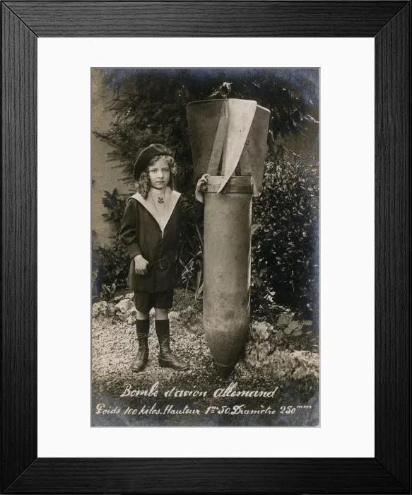 Framed Print : WW1 - Small French Child with a huge Unexploded German Bomb Framed Print : WW1 - Small French Child with a huge Unexploded German Bomb