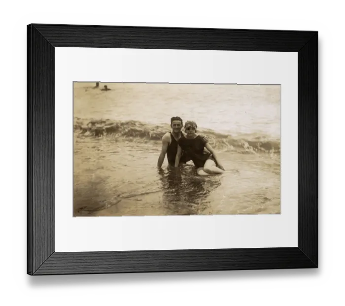 Framed Print : Couple sitting in surf - British seaside candid photograph Framed Print : Couple sitting in surf - British seaside candid photograph