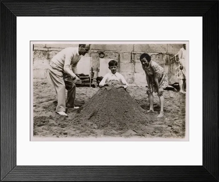 Framed Print : Father and daughter bury son (brother), British seaside Framed Print : Father and daughter bury son (brother), British seaside