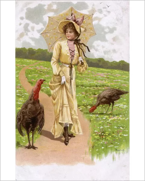 Pretty girl walking along a rural path with two turkeys
