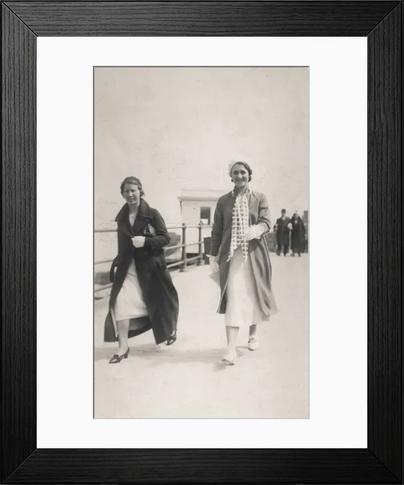 Framed Print : Two women stroll along the seafront Framed Print : Two women stroll along the seafront