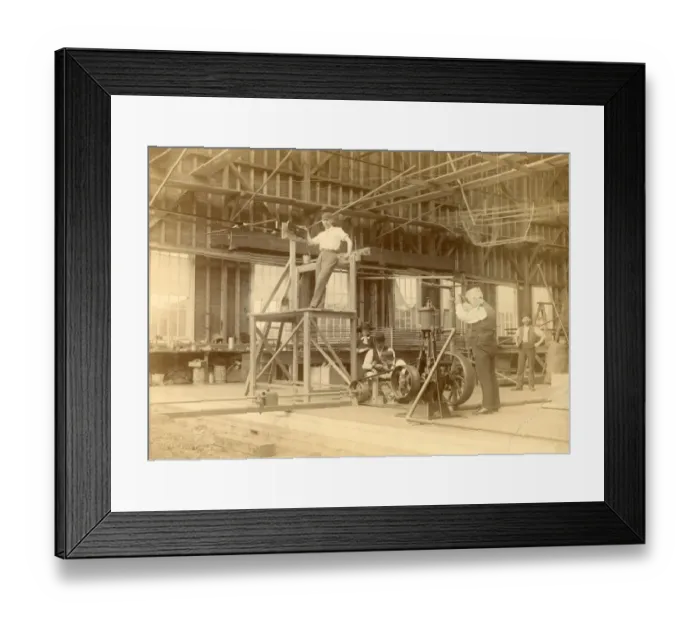 Framed Print : Sir Hiram Maxim operating the valve of the steam engine?