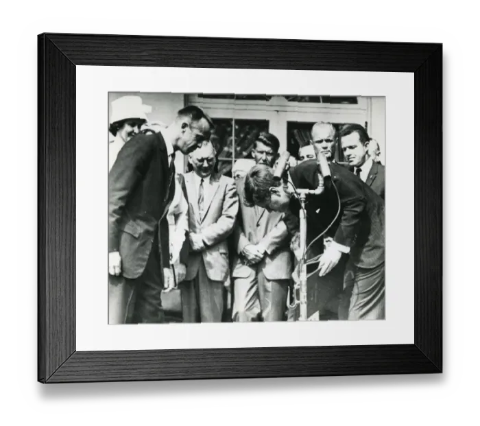 Framed Print : President John F. Kennedy stoops to retrieve the Nation? Framed Print : President John F. Kennedy stoops to retrieve the Nation?