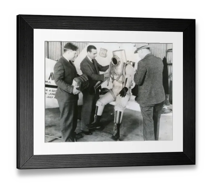 Framed Print : Wiley Post makes a final examination of his pressure suit Framed Print : Wiley Post makes a final examination of his pressure suit