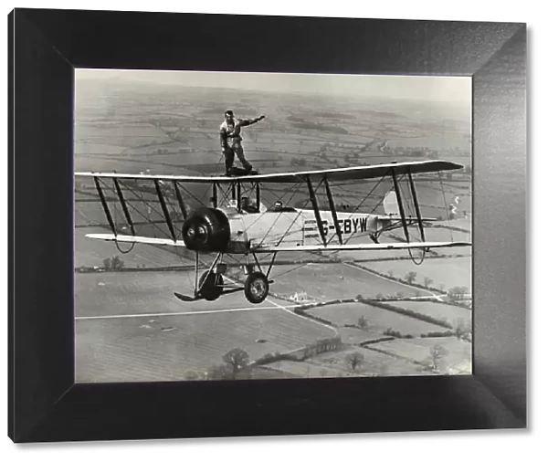 Avro 504K. Wing-Walking on an Avro 504K Flying over Fields Date: 1920s