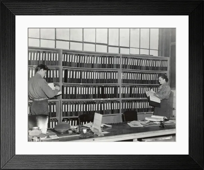 Framed Print : An Airman and Woman in the Office of the Headquarters of? Framed Print : An Airman and Woman in the Office of the Headquarters of?