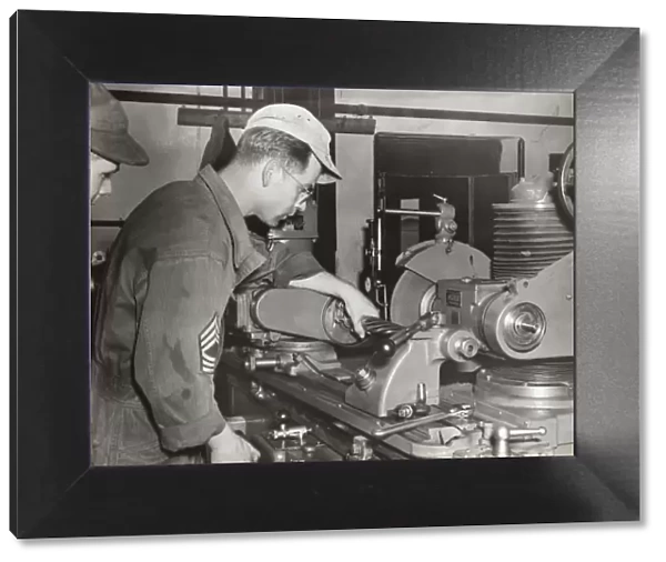 A Foreman and an Airman Check a Grinding Machine at the ?