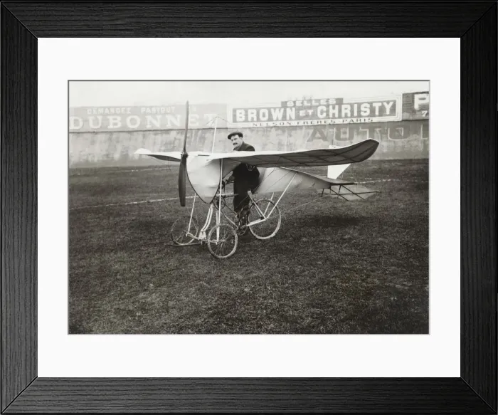 Framed Print : Pilot Sitting on Bi-Cycle Aircraft with Adverts in the ? Framed Print : Pilot Sitting on Bi-Cycle Aircraft with Adverts in the ?