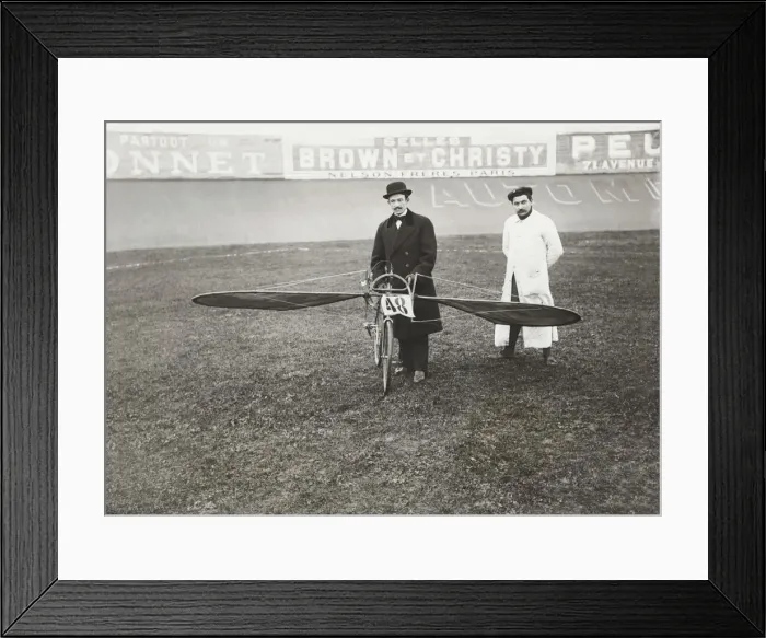 Framed Print : Men Standing with Bi-Cycle Aircraft with Adverts in Fren? Framed Print : Men Standing with Bi-Cycle Aircraft with Adverts in Fren?