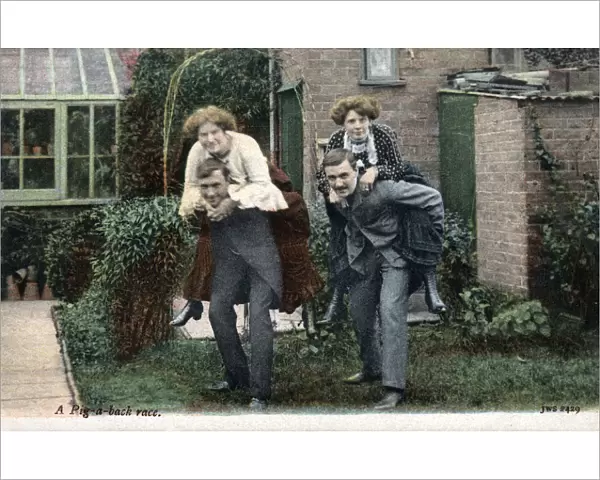 Two Couples have a piggy-back race in the back garden