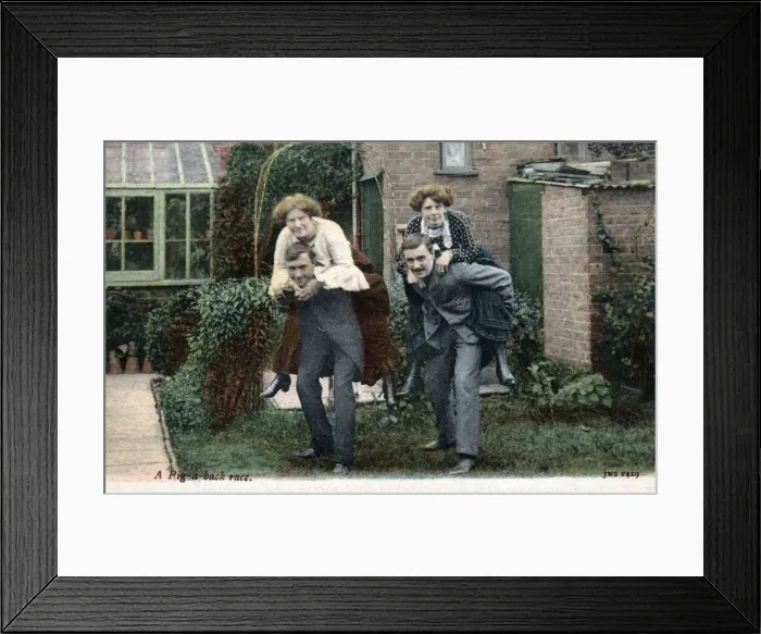 Framed Print : Two Couples have a piggy-back race in the back garden Framed Print : Two Couples have a piggy-back race in the back garden