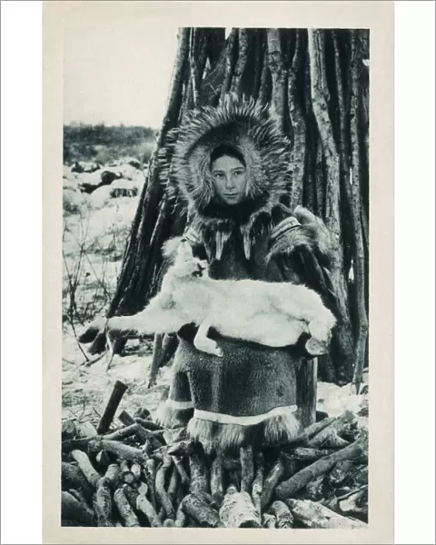 Young Eskimo (Inuit) girl with a captured Arctic Hare