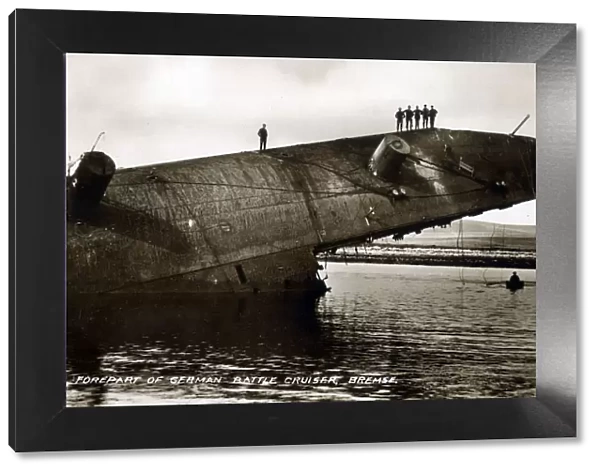 Men stand on forepart of part-submerged German Battlecruiser