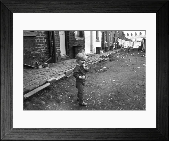 Framed Print : Boy in slum housing yard Framed Print : Boy in slum housing yard