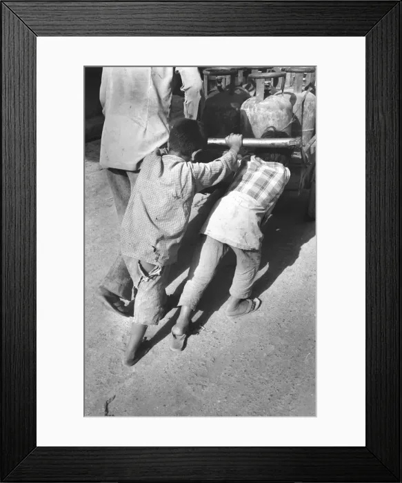 Framed Print : Boys push loaded cart Framed Print : Boys push loaded cart