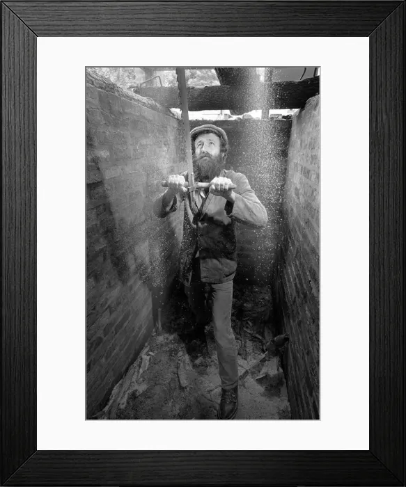 Framed Print : The bottom sawyer in a saw pit cutting a timber log into pla Framed Print : The bottom sawyer in a saw pit cutting a timber log into pla