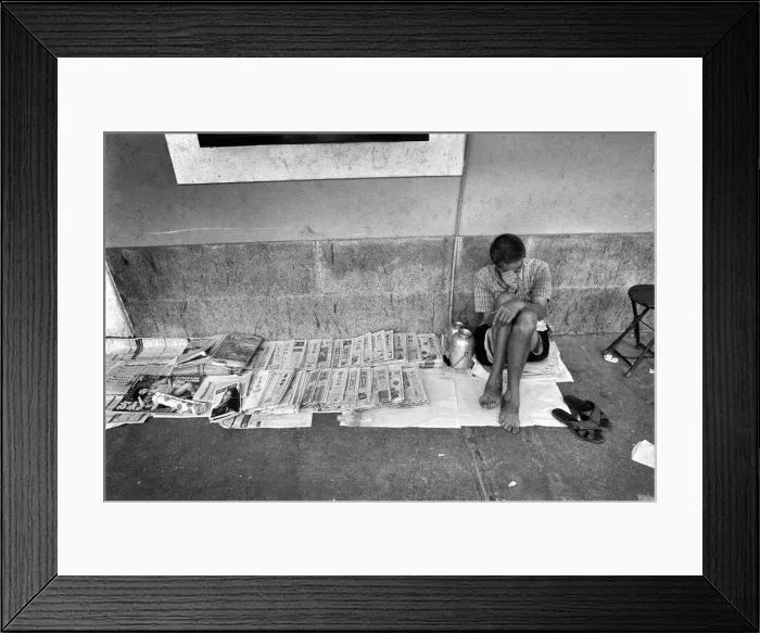 Framed Print : A newpaper seller sits on the pavement in a street in Canton Framed Print : A newpaper seller sits on the pavement in a street in Canton