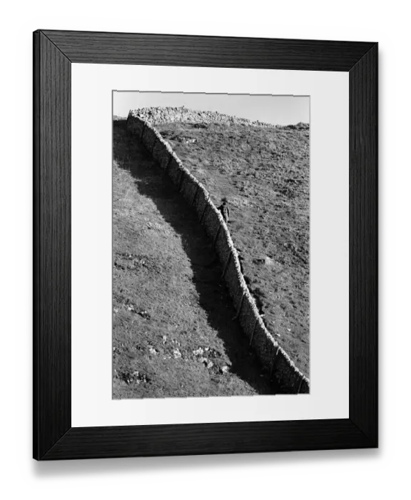 Framed Print : Hiker holds on to a stone wall on steep hill, Peak District Framed Print : Hiker holds on to a stone wall on steep hill, Peak District