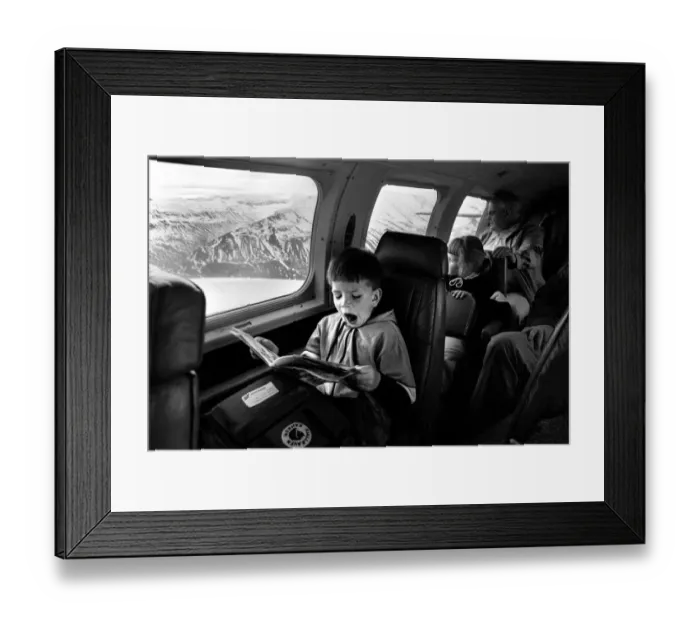 Framed Print : Yawning boy reads comic during an internal flight in Iceland Framed Print : Yawning boy reads comic during an internal flight in Iceland